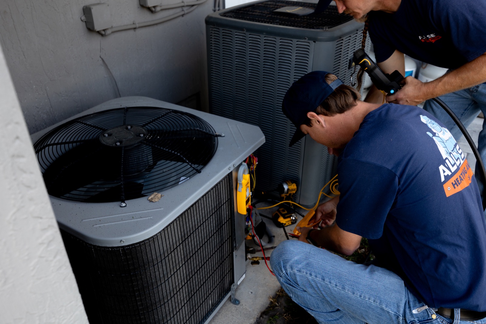 All Set HVAC technician servicing an outdoor AC unit